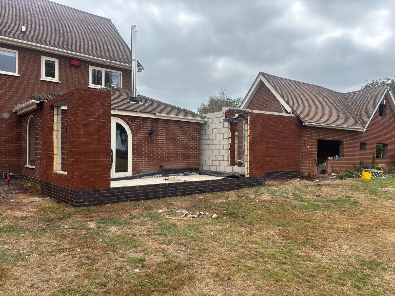 Brickwork extension with contrasting black brick plinth