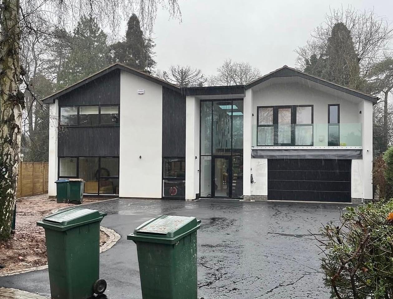 Contemporary new-build extension with dark cladding and glazing