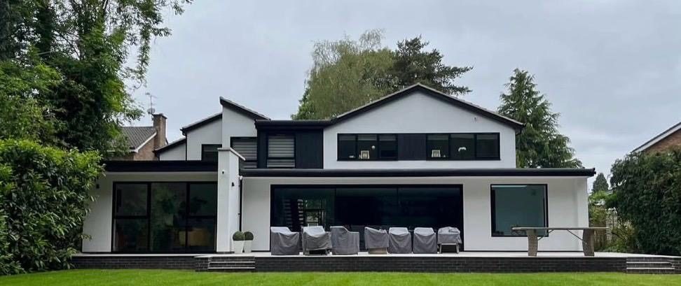 Finished white-rendered extension with brick base course