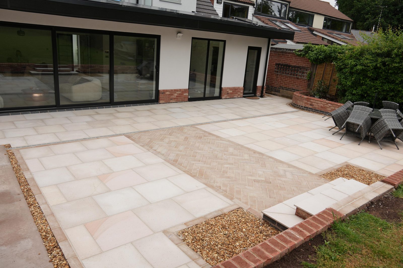 Sandstone patio with herringbone brick paving detail